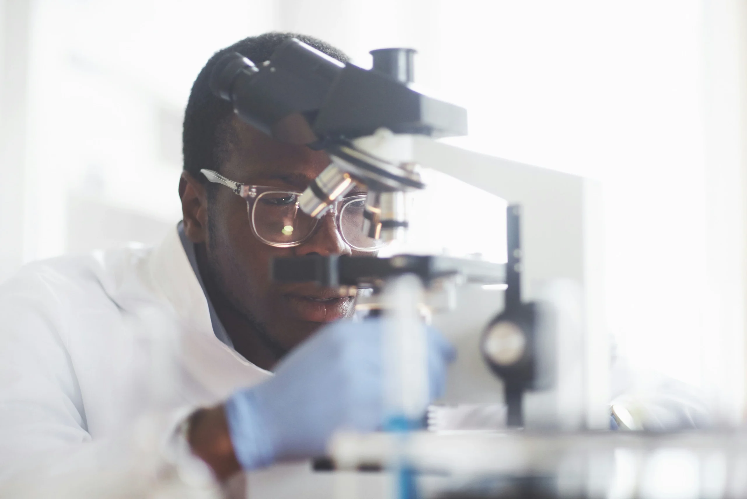 Lab technician working at microscope at AccuDiagnostics